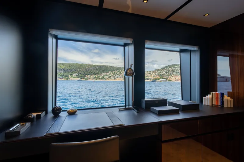 Tasty Waves Yacht Photos Pics Luxurious office interior on 2025 Riva 130' Bellissima yacht with scenic ocean view.