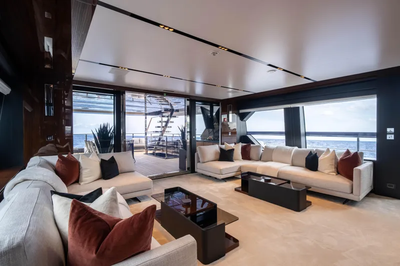 Tasty Waves Yacht Photos Pics Luxurious interior of 2025 Riva 130' Bellissima yacht with ocean view and elegant seating.
