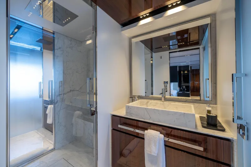 Tasty Waves Yacht Photos Pics Luxurious bathroom on 2025 Riva 130' Bellissima yacht with marble sink and modern shower.