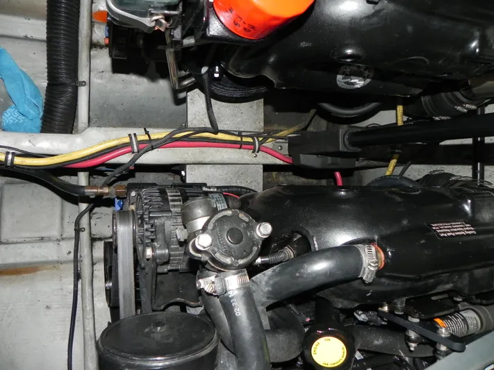 Yours To Name Yacht Photos Pics Engine compartment of a 2015 Chris-Craft 28 Heritage Corsair boat, showing mechanical components.