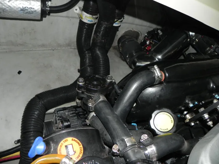 Yours To Name Yacht Photos Pics Engine compartment of 2015 Chris-Craft 28 Heritage Corsair with visible hoses and components.