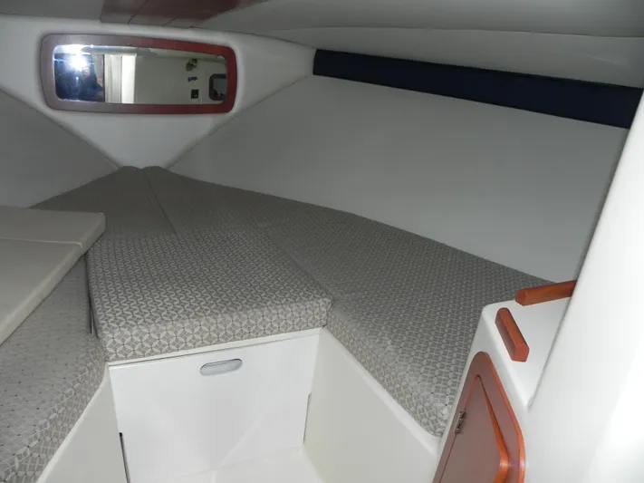 Yours To Name Yacht Photos Pics 2015 Chris-Craft 28 Heritage Corsair cabin interior with cushioned seating and storage.