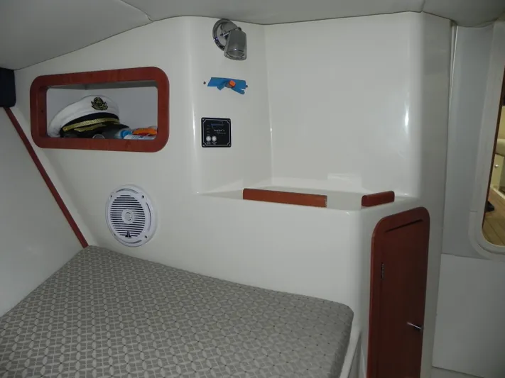 Yours To Name Yacht Photos Pics Interior cabin of 2015 Chris-Craft 28 Heritage Corsair with bed and storage.