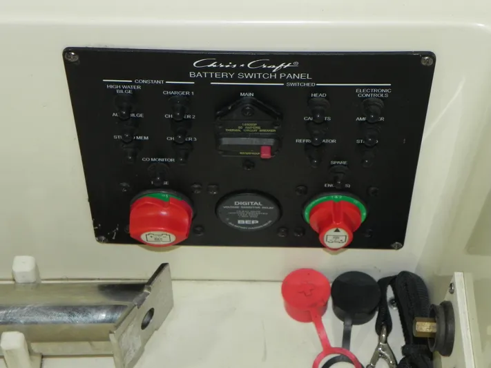 Yours To Name Yacht Photos Pics Battery switch panel of 2015 Chris-Craft 28 Heritage Corsair boat with controls and indicators.