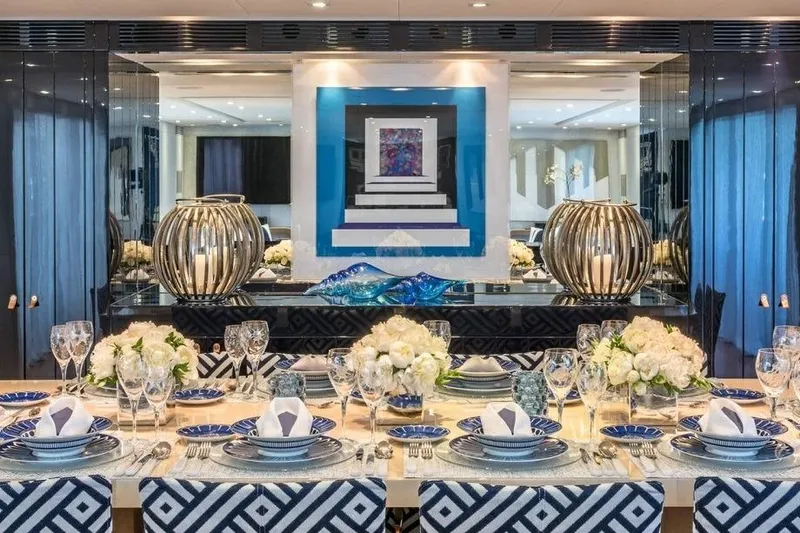 Lucky Me Yacht Photos Pics Luxurious dining area on 2010 Baglietto 41 yacht with elegant table setting and modern decor.