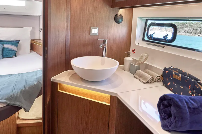  Yacht Photos Pics Luxurious bathroom interior of 2026 Beneteau Antares 12 yacht with modern amenities.