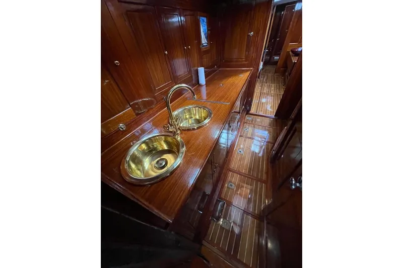  Yacht Photos Pics Luxurious wooden interior of 1912 Fred Shepherd 70 ft Bermudan yawl with brass sink fixtures.