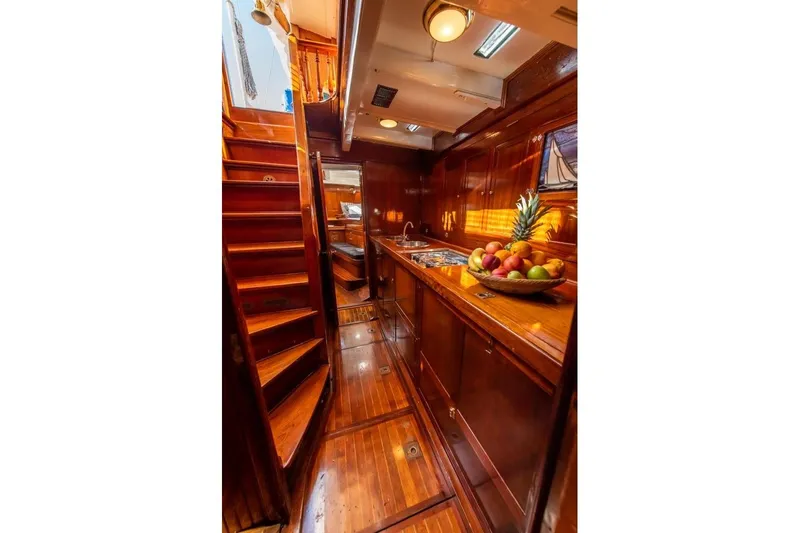  Yacht Photos Pics Luxurious wooden interior of 1912 Fred Shepherd 70 ft Bermudan yawl, featuring a fruit bowl.