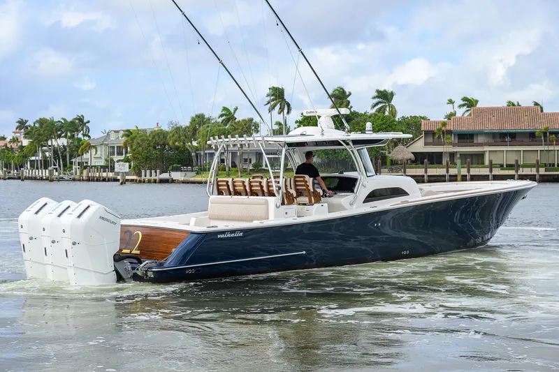 22 Yacht Photos Pics 2022 Valhalla V-46 Center Console boat cruising on a scenic waterway.