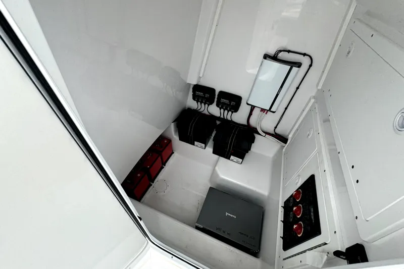  Yacht Photos Pics 2024 Bluewater 25t boat electrical compartment with batteries and wiring.