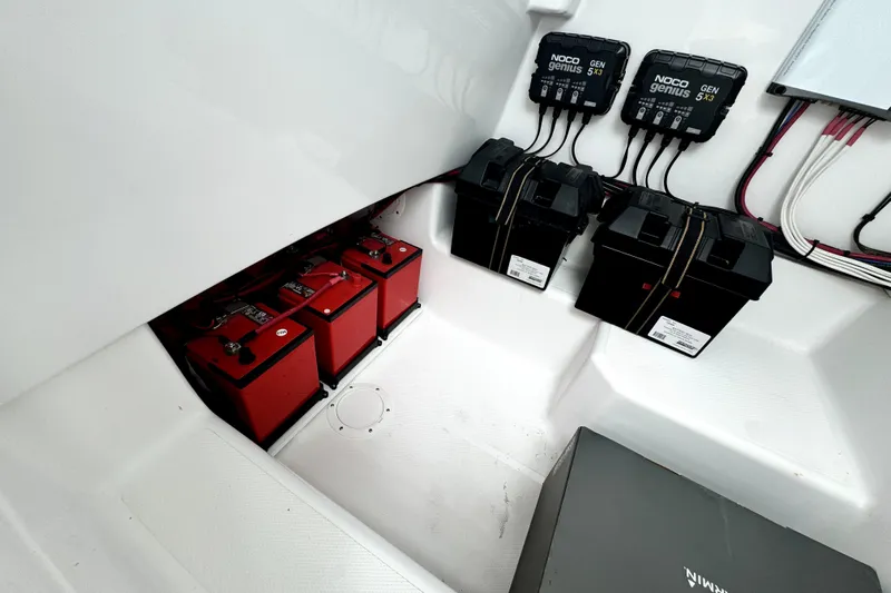  Yacht Photos Pics 2024 Bluewater 25t boat battery compartment with red batteries and NOCO Genius chargers.