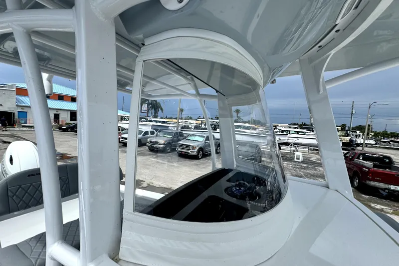  Yacht Photos Pics 2024 Bluewater 25t boat interior with clear canopy, parked in a marina.