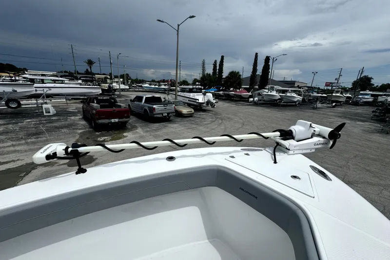  Yacht Photos Pics 2024 Bluewater 25t boat with Garmin trolling motor in a marina parking lot.