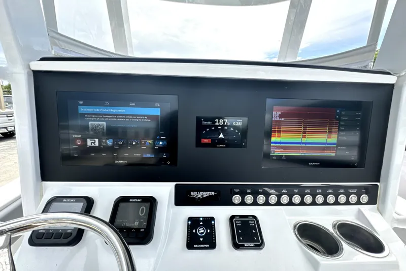  Yacht Photos Pics 2024 Bluewater 25t boat dashboard with dual Garmin displays and Suzuki controls.