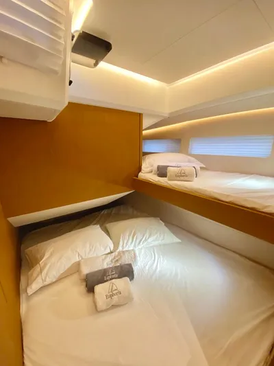 Euphoria Yacht Photos Pics Cozy cabin interior of 2021 Jeanneau 60 yacht with neatly arranged bedding.
