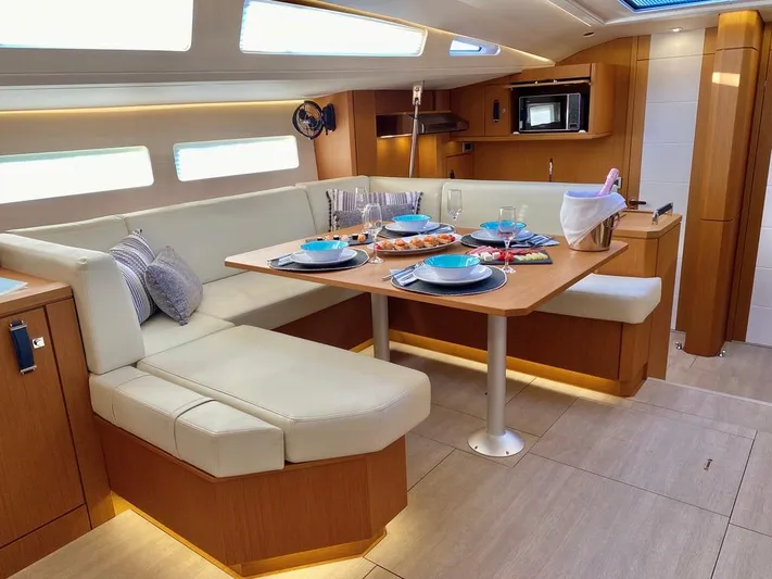 Euphoria Yacht Photos Pics Luxurious interior of 2021 Jeanneau 60 yacht with elegant dining area and modern amenities.