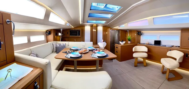 Euphoria Yacht Photos Pics Luxurious interior of 2021 Jeanneau 60 yacht with elegant dining area and modern furnishings.