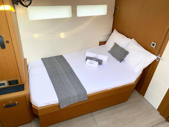 Euphoria Yacht Photos Pics Luxurious cabin interior of 2021 Jeanneau 60 yacht with neatly made bed.