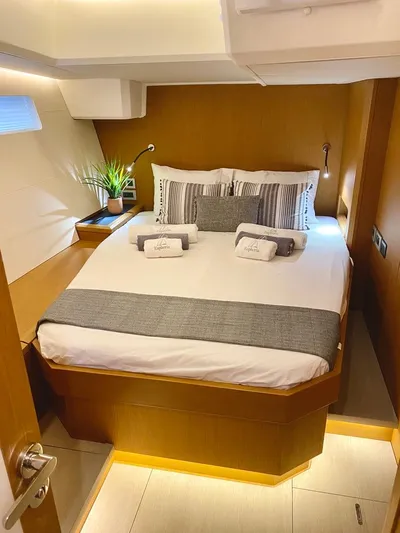 Euphoria Yacht Photos Pics Luxurious cabin interior of 2021 Jeanneau 60 yacht with modern bedding and ambient lighting.