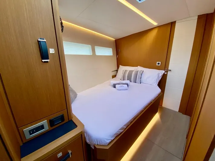 Euphoria Yacht Photos Pics Luxurious cabin interior of 2021 Jeanneau 60 yacht with cozy bed and modern lighting.