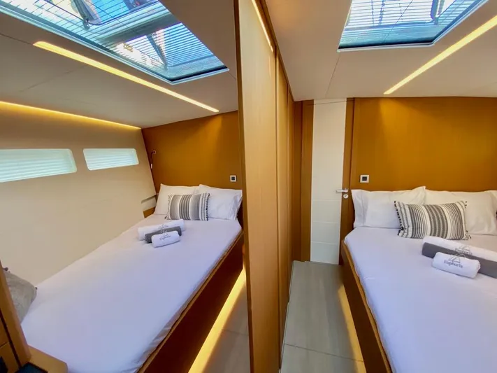 Euphoria Yacht Photos Pics Luxurious interior of 2021 Jeanneau 60 yacht with twin beds and skylights.