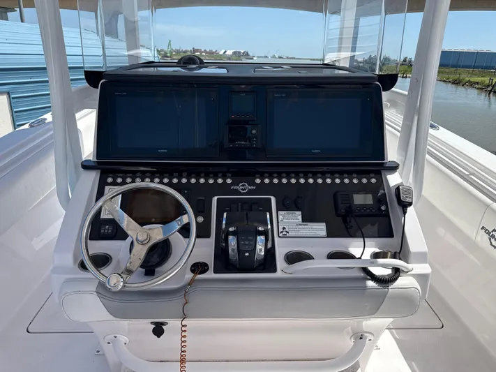  Yacht Photos Pics 2018 Fountain 38cc boat dashboard with steering wheel and control panel.