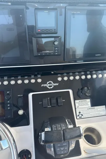  Yacht Photos Pics Control panel of a 2018 Fountain 38cc boat with navigation screens and controls.