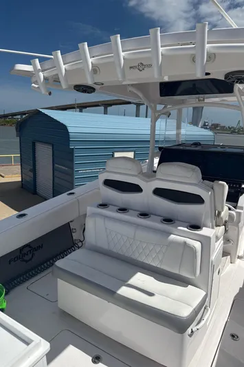  Yacht Photos Pics 2018 Fountain 38cc boat interior with seating and rod holders under a clear sky.
