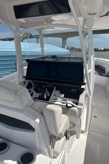  Yacht Photos Pics 2018 Fountain 38cc boat interior with modern dashboard and seating.
