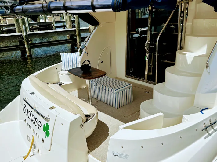 Saoirse Yacht Photos Pics 2011 Meridian 441 Sedan yacht with seating area and striped cushions at a marina.