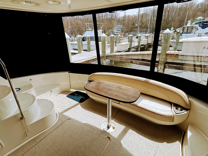 Saoirse Yacht Photos Pics Interior of 2011 Meridian 441 Sedan yacht with seating and table, dock view.