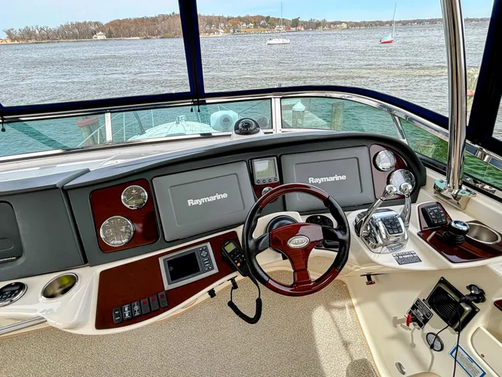 Saoirse Yacht Photos Pics Helm of 2011 Meridian 441 Sedan with Raymarine navigation, overlooking serene waters.