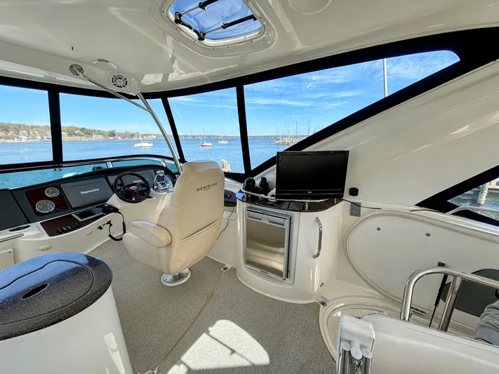 Saoirse Yacht Photos Pics Interior of a 2011 Meridian 441 Sedan yacht with helm and scenic water view.