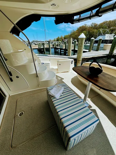 Saoirse Yacht Photos Pics 2011 Meridian 441 Sedan yacht interior with striped seating, table, and marina view.