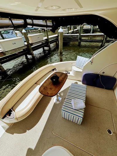 Saoirse Yacht Photos Pics 2011 Meridian 441 Sedan yacht interior with seating, table, and striped cushion at a marina.