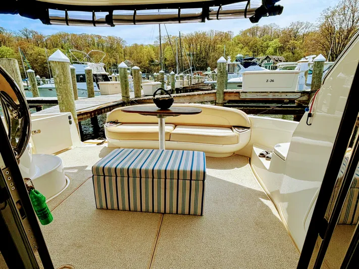 Saoirse Yacht Photos Pics Luxurious 2011 Meridian 441 Sedan yacht interior with seating and striped ottoman at marina.