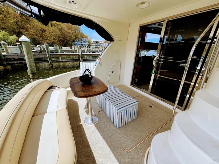 Saoirse Yacht Photos Pics Luxurious 2011 Meridian 441 Sedan yacht deck with seating, table, and marina view.