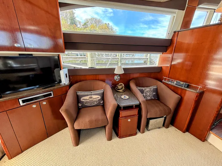 Saoirse Yacht Photos Pics Luxurious interior of a 2011 Meridian 441 Sedan yacht with plush seating and elegant wood finishes.