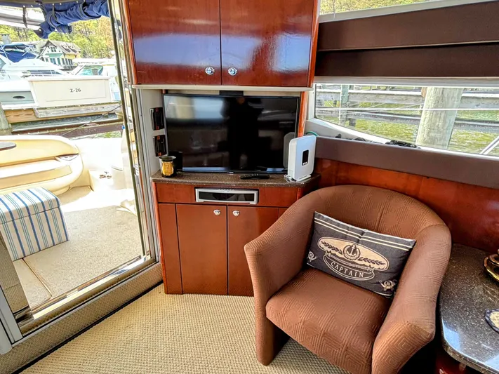 Saoirse Yacht Photos Pics Interior of 2011 Meridian 441 Sedan yacht with TV, chair, and nautical decor.