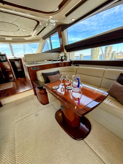 Saoirse Yacht Photos Pics Luxurious interior of 2011 Meridian 441 Sedan yacht with elegant seating and wooden table.
