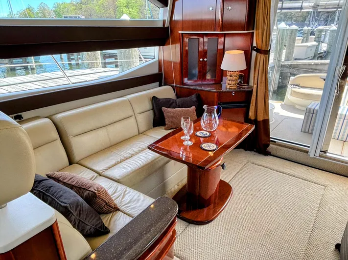 Saoirse Yacht Photos Pics Luxurious interior of 2011 Meridian 441 Sedan yacht with elegant seating and wooden table.