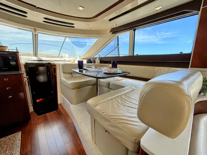 Saoirse Yacht Photos Pics Luxurious interior of a 2011 Meridian 441 Sedan yacht with leather seating and dining area.