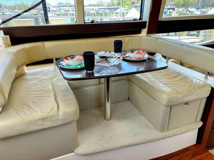 Saoirse Yacht Photos Pics Luxurious dining area inside a 2011 Meridian 441 Sedan yacht with elegant tableware.