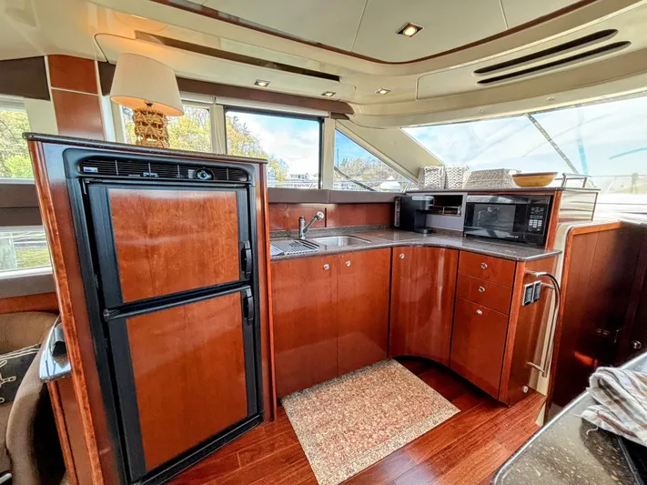 Saoirse Yacht Photos Pics Luxurious kitchen interior of 2011 Meridian 441 Sedan yacht with wood cabinetry and modern appliances.