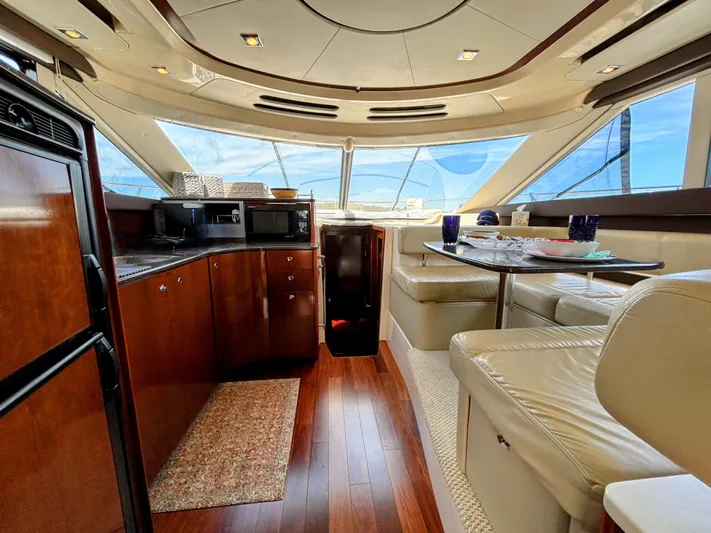 Saoirse Yacht Photos Pics Luxurious interior of 2011 Meridian 441 Sedan yacht with elegant seating and kitchen area.