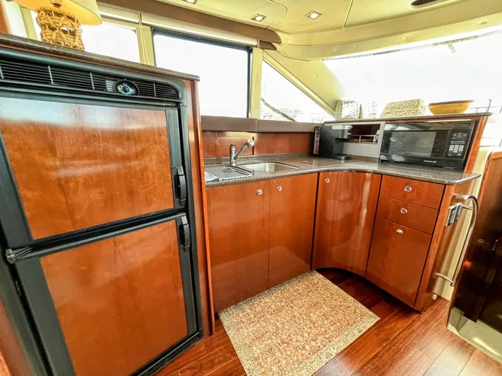 Saoirse Yacht Photos Pics Luxurious 2011 Meridian 441 Sedan yacht kitchen with wood cabinetry, sink, and appliances.