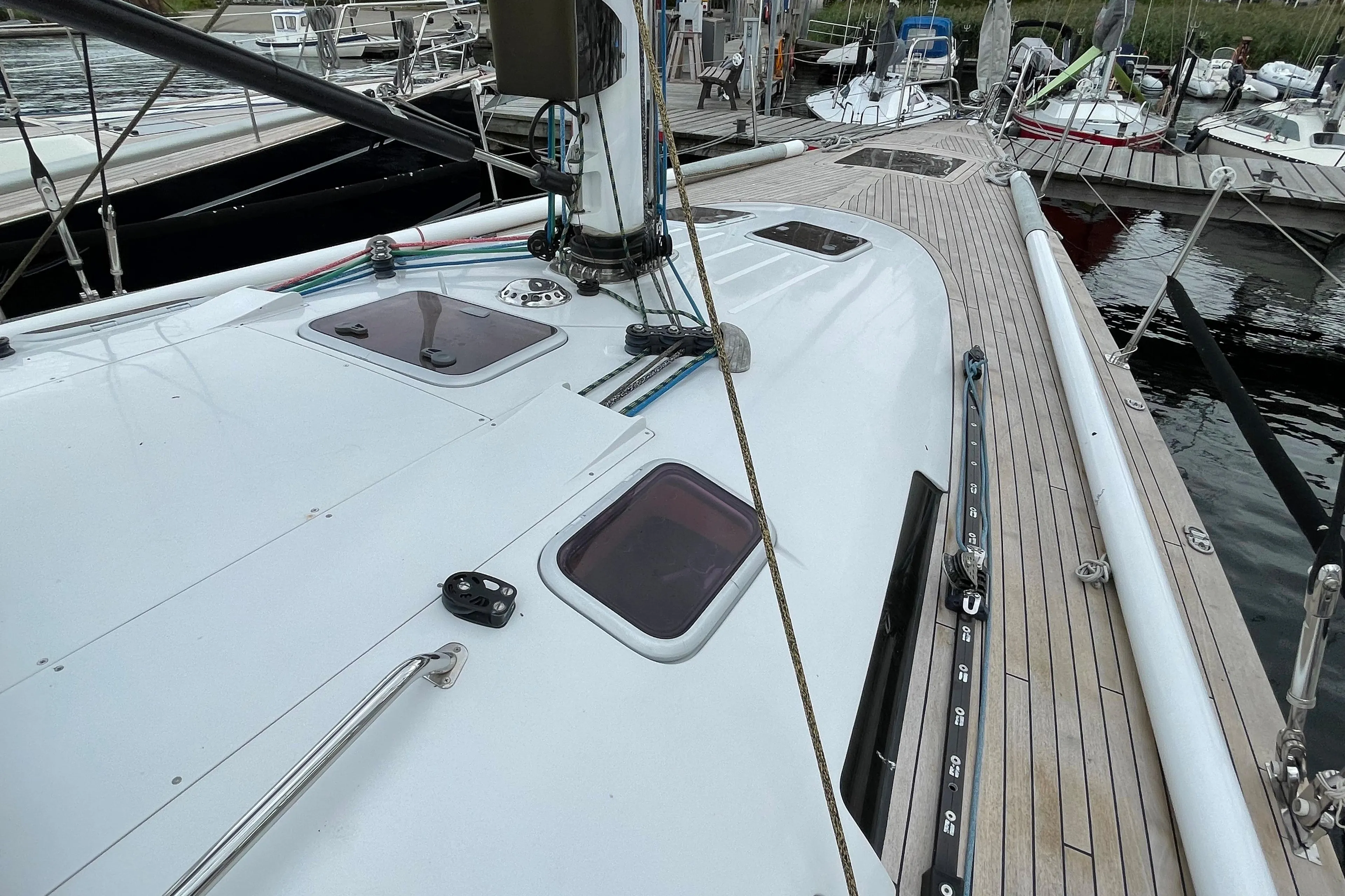 Sailboat deck view of 2005 Comet 45 S, docked at marina with visible hatches.