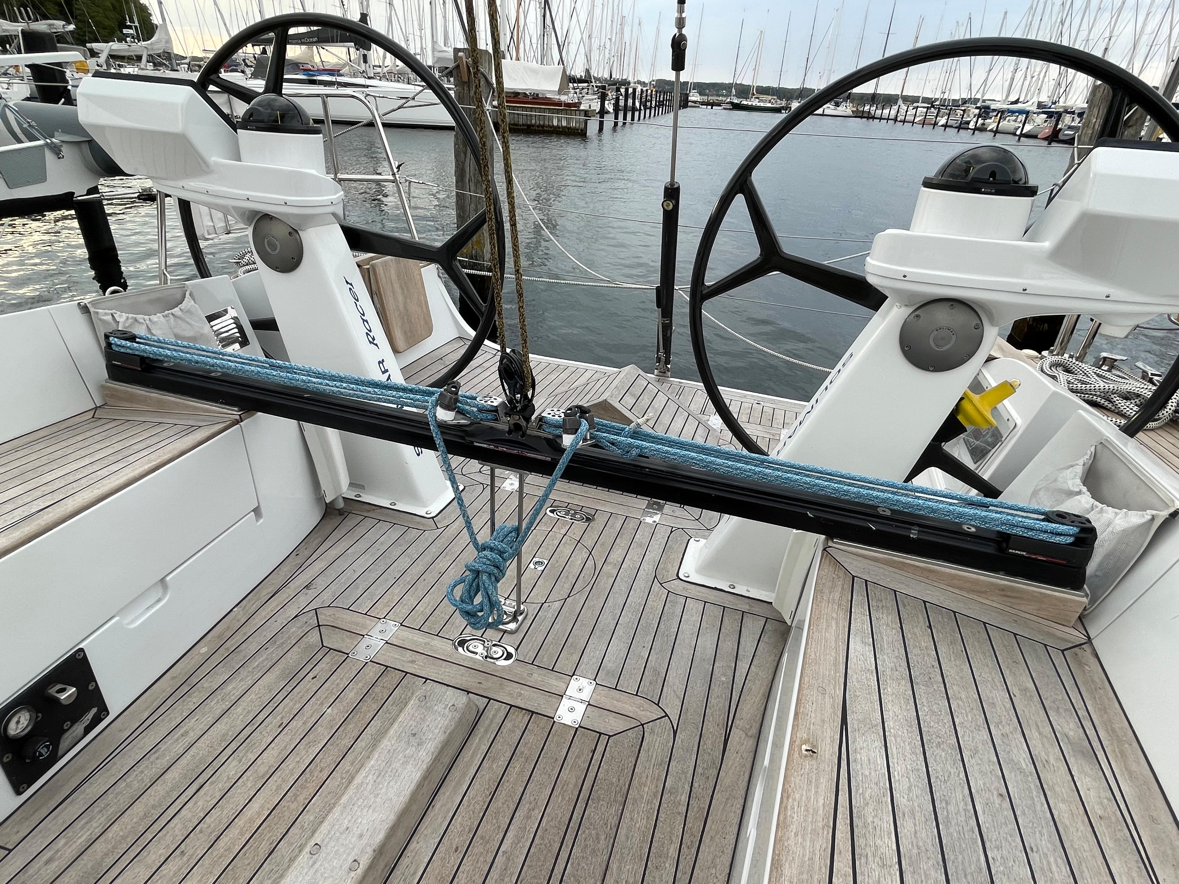 Dual steering wheels on a 2005 Comet 45 S yacht, docked at a marina.