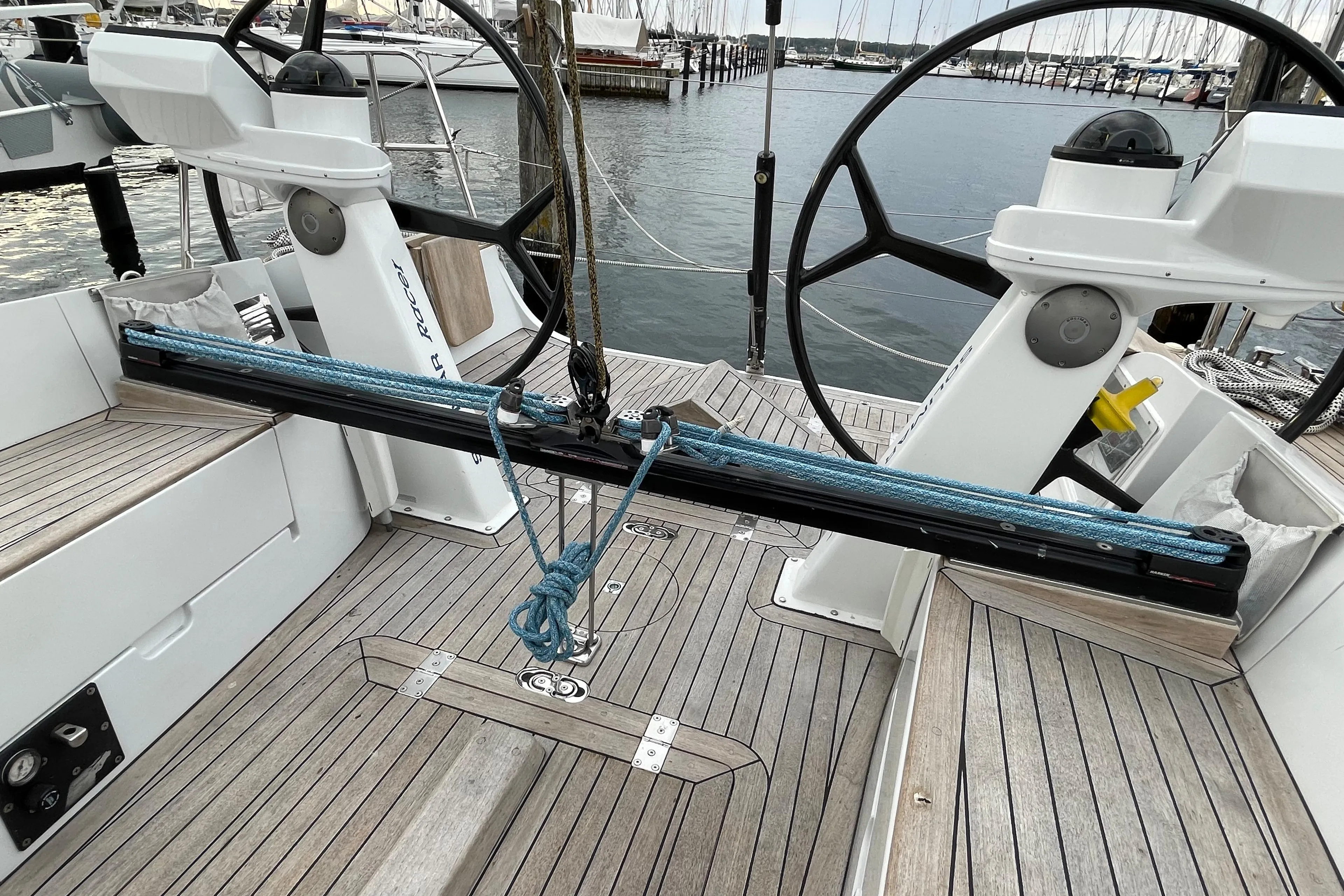 Dual steering wheels on a 2005 Comet 45 S yacht, docked at a marina.