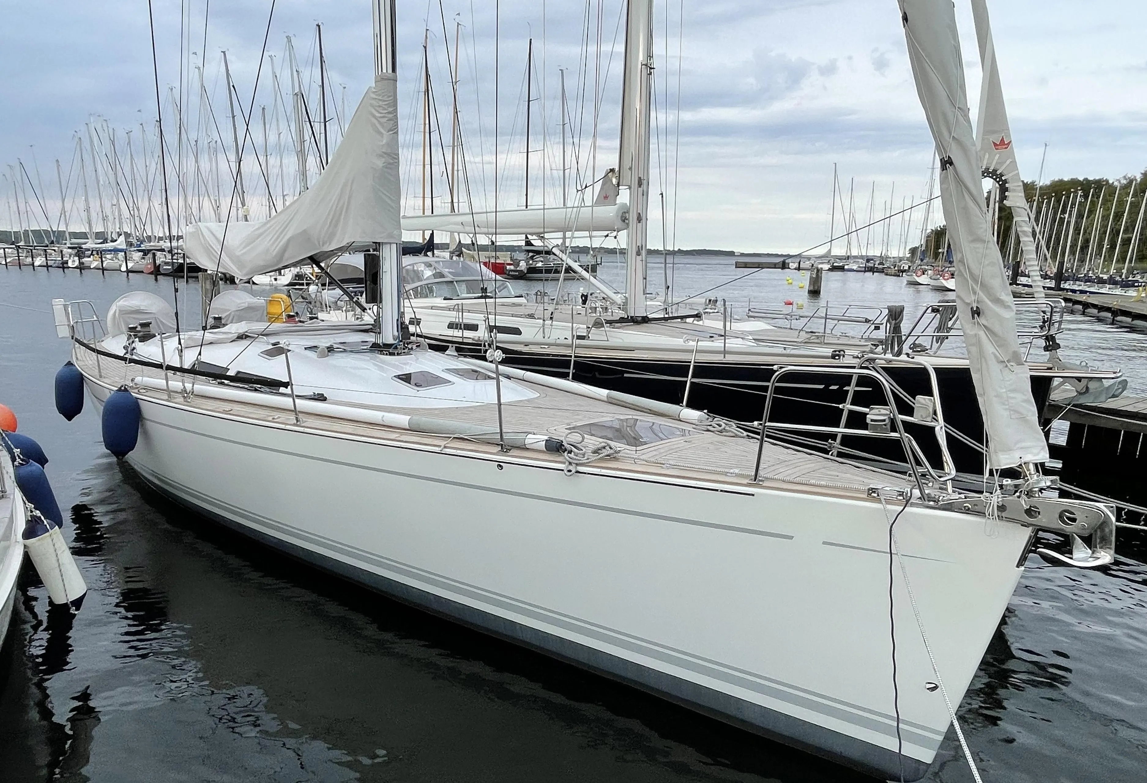 Sailing yacht Comet 45 S, 2005 model, docked at marina with calm waters.